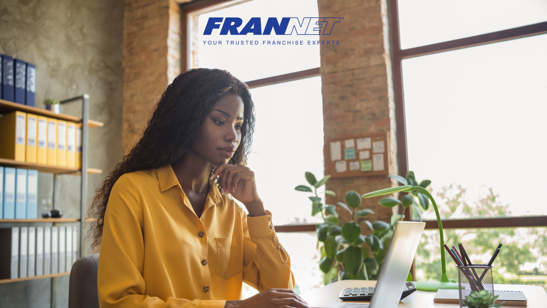 Woman working on laptop at desk