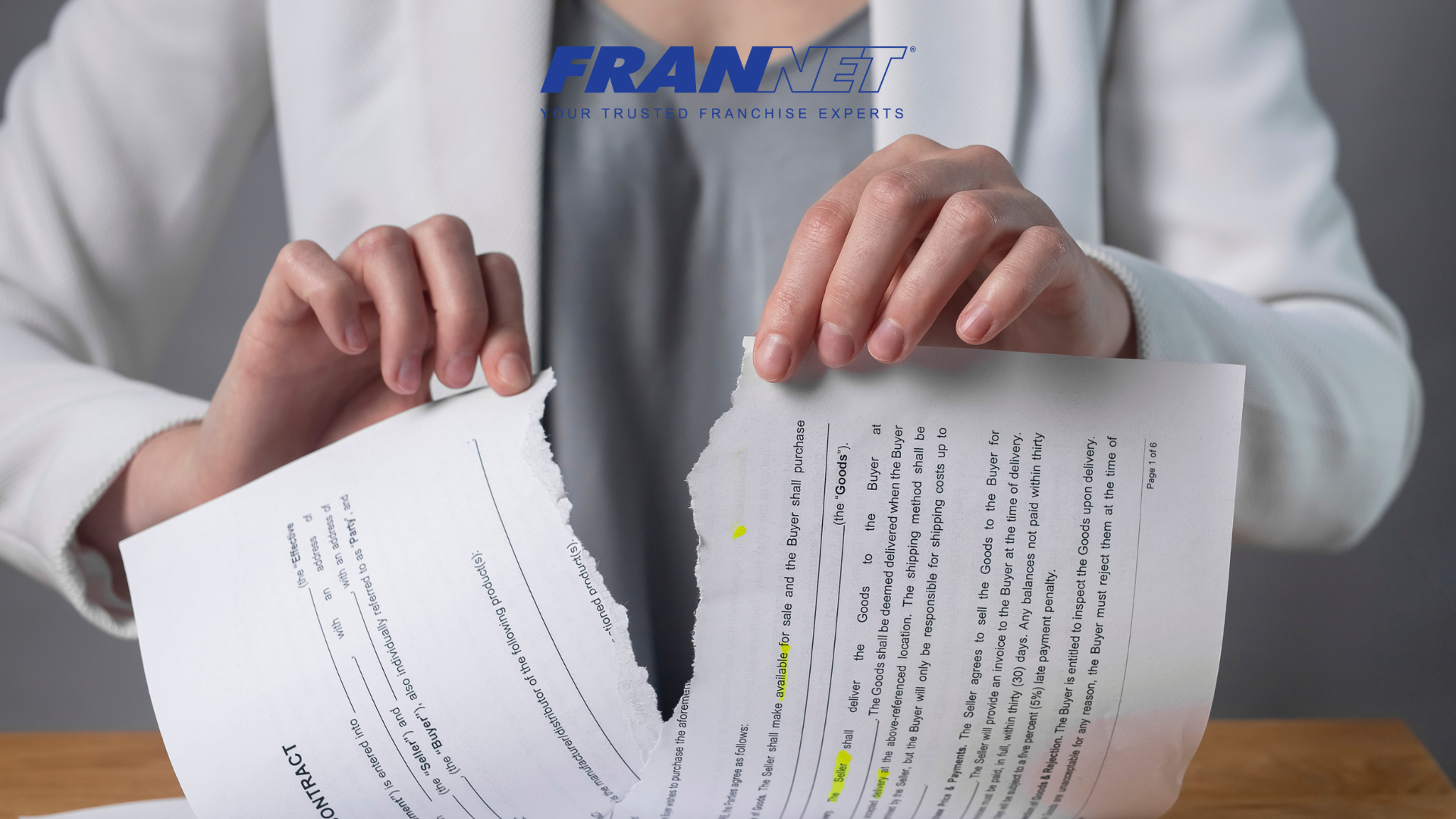 Woman tearing a contract representing how to get out of a franchise agreement