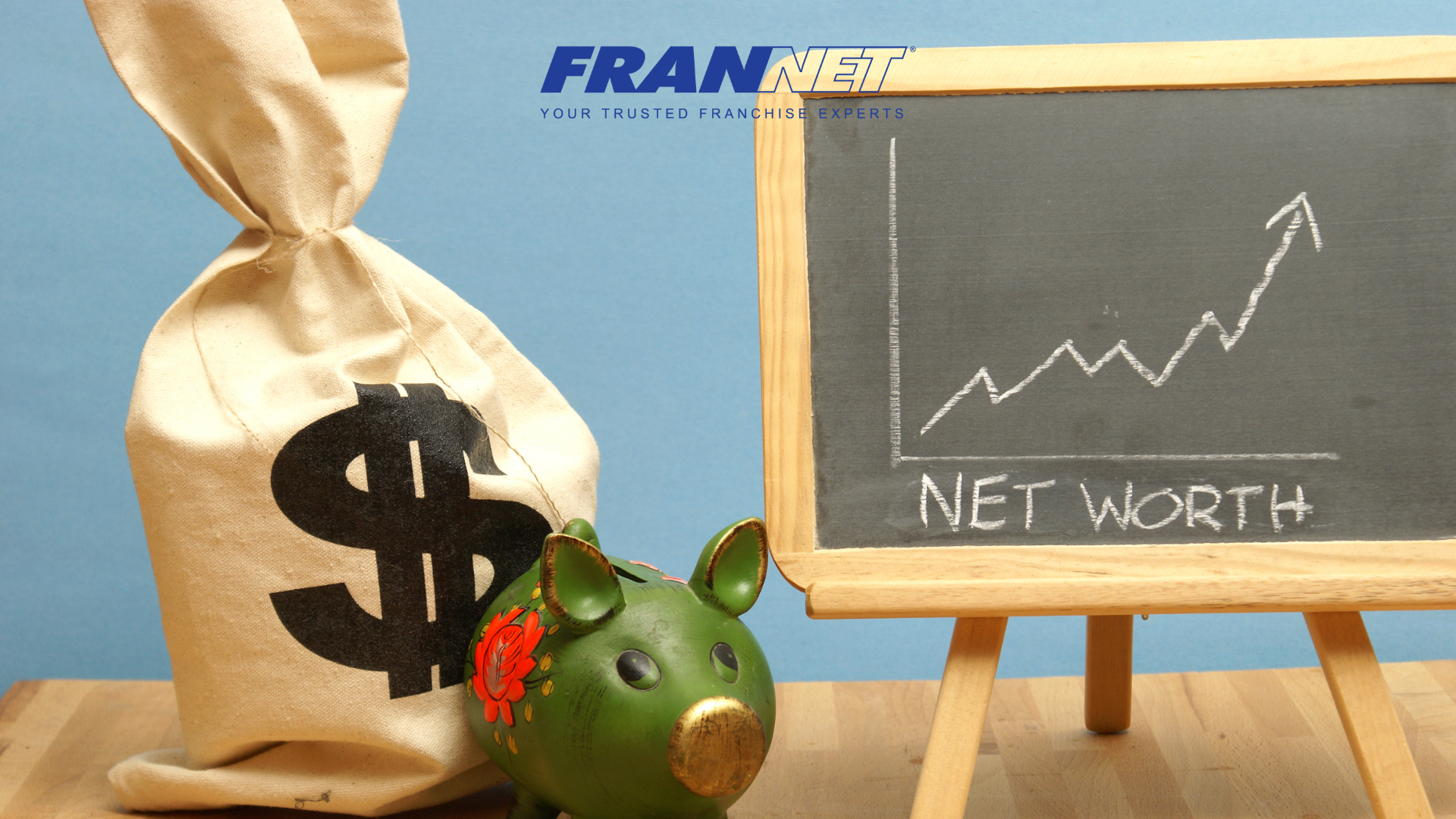 Bag of money and piggy bank with chalk board that has arrow pointing up and says net worth