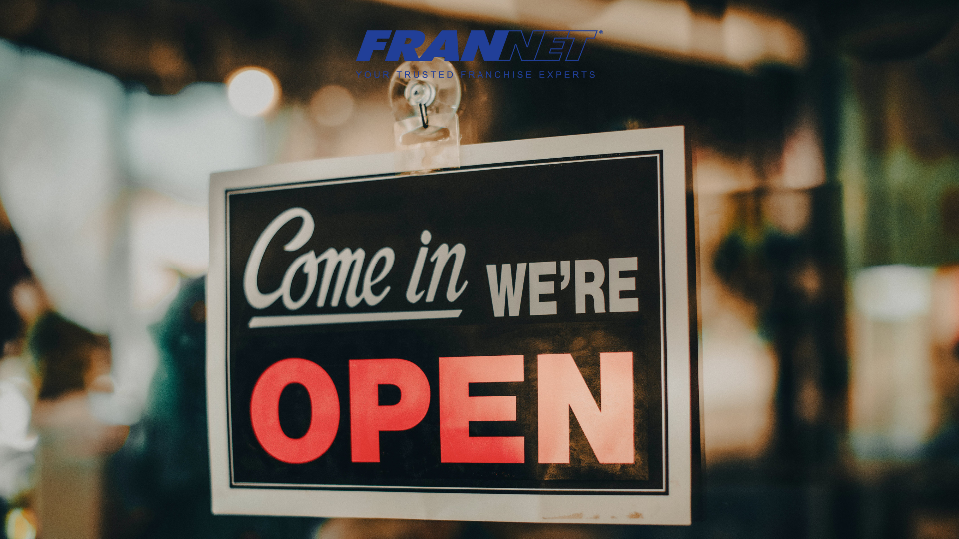 "Come in, we're open" sign - blog answering the question "how long does it take to open a franchise business"