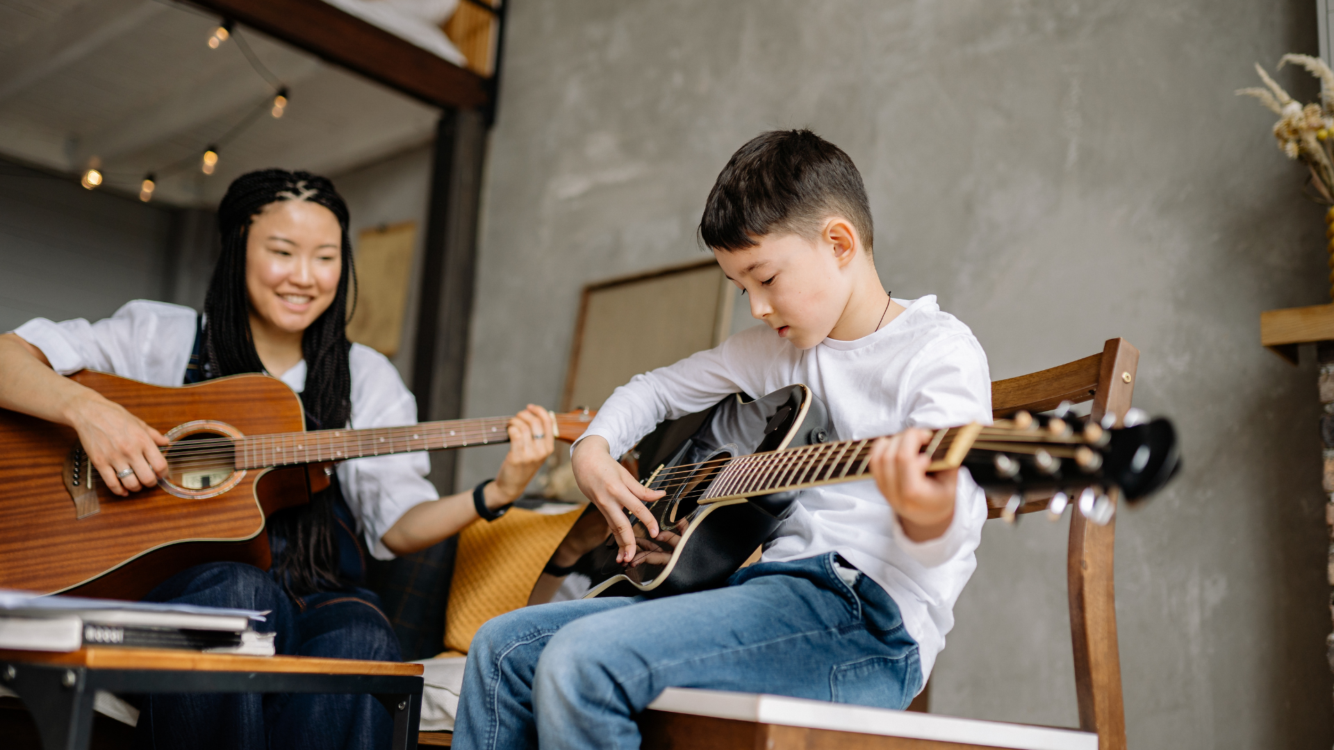 Young boy taking guitar lessons representing music franchise opportunities