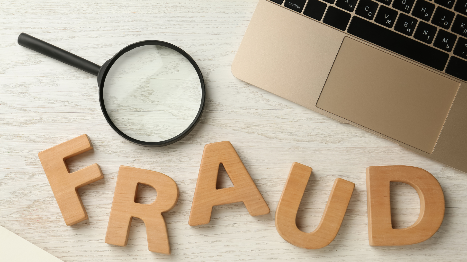 Magnifying glass next to "fraud" representing the idea of Identifying franchise fraud